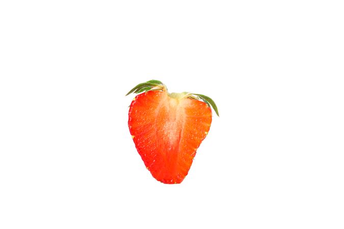 Half of strawberry isolated on light background. Summer sweet fruits and berries