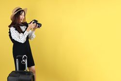 Young Female Traveller Smiling While  Review Photo on Her Camera