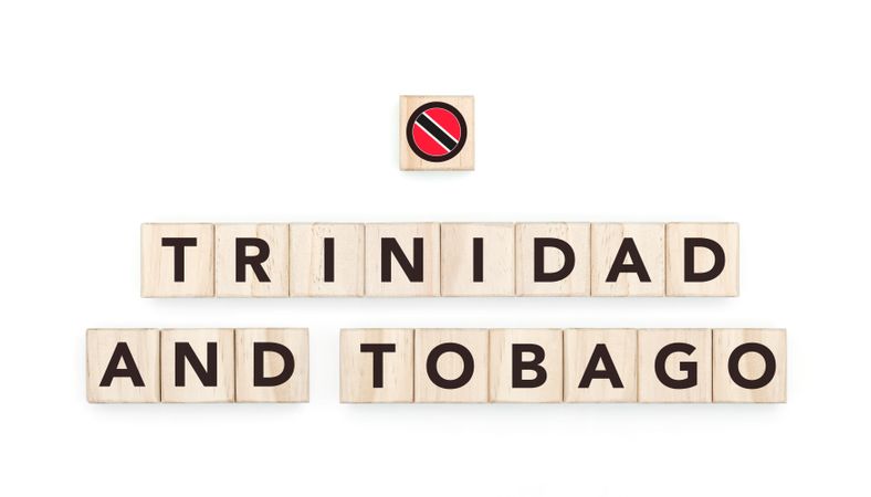 Wooden blocks bearing the name and flag of Trinidad And Tobago. Trinibagonian and Caribbean Culture, national identity, travel, and geography in a copy space design.