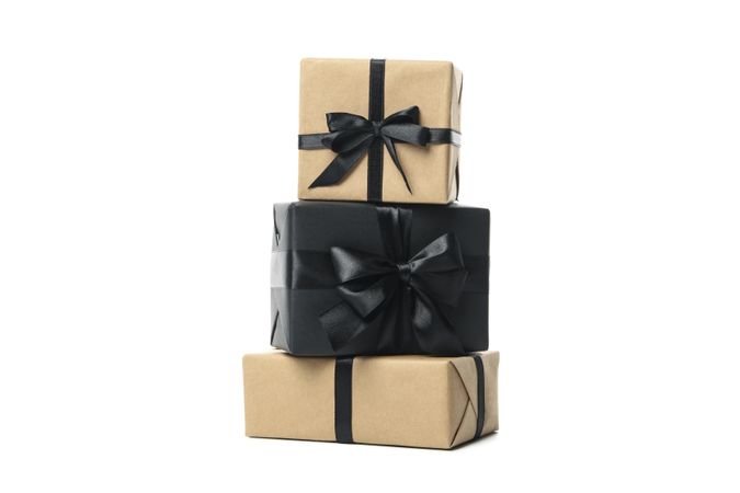 Gift boxes with dark bow isolated on plain background