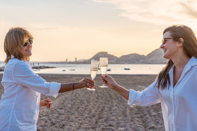 Happy family drinking wine on beach