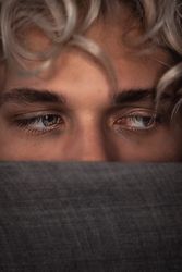 Young man's guilty blue eyes