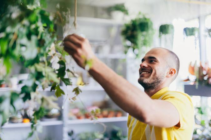 Man taking care of plants in the flower shop.