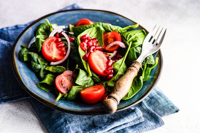 Bowl organic salad with spinach and pomegranate