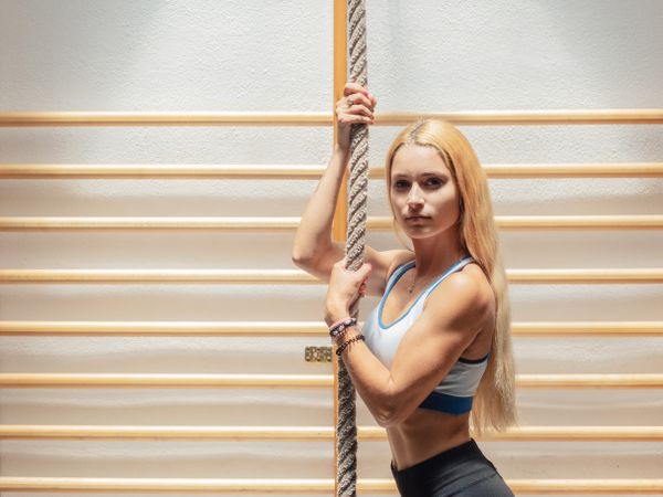 Female training with rope in gym