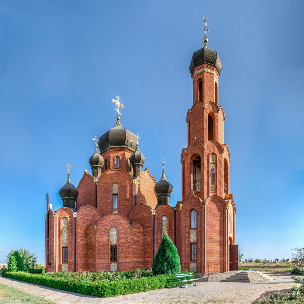 Brown concrete church under blue sky