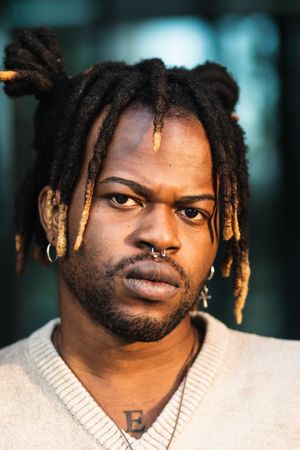 Modern guy with dreadlocks and in accessories
