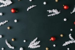 Christmas tree branches with red decorations on dark table background