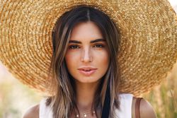 Portrait of beautiful woman in straw hat