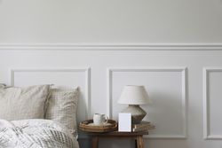 Bedside table with tray of coffee, lamp with blank card