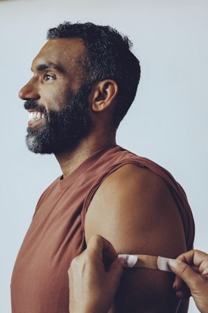 Man having bandaid placed after vaccination