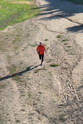 Looking down at male jogging through track in the park