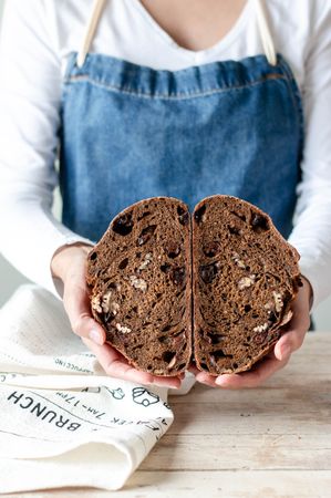 Hands of woman holding rye bread