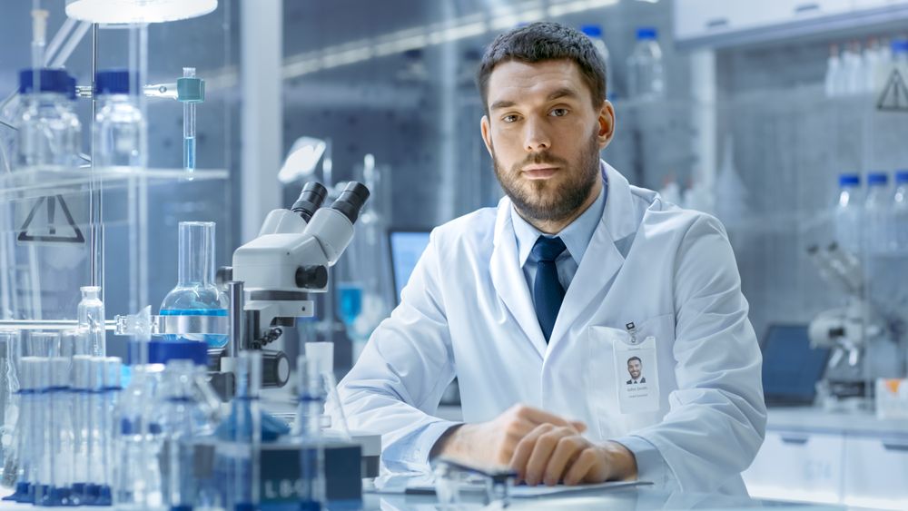Young Male Research Scientist Talks Into Camera.