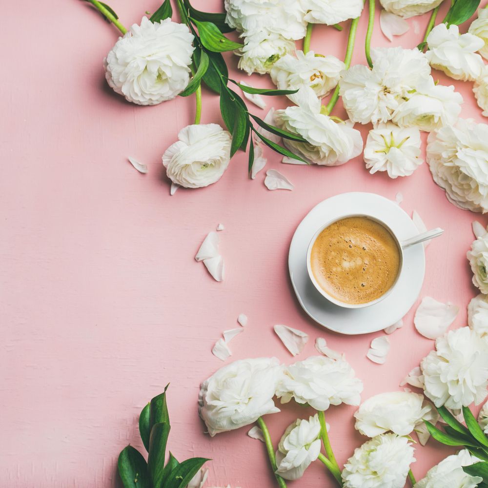 Morning caffeine with pretty flowers over pink background