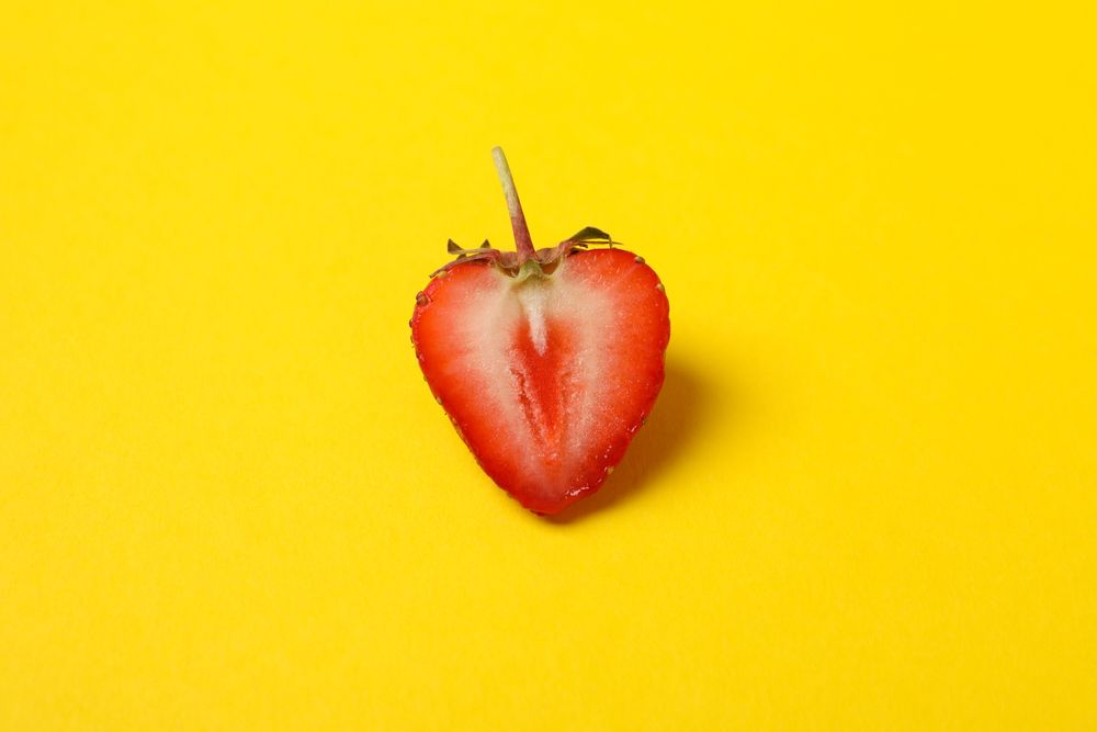 Tasty strawberry on yellow background. Summer berry