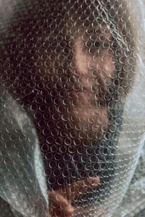Woman entangled in bubble wrap