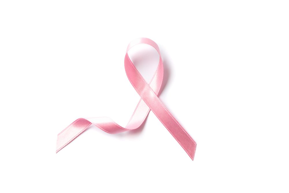Pink awareness ribbon isolated on blank background, top view