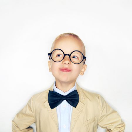 Curious blond boy in glasses and bow tie