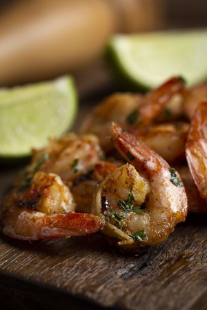 Delicious grilled prawns on wooden background.