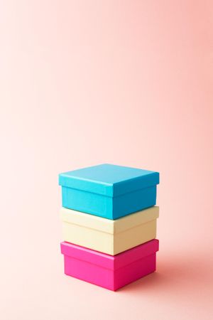 Three stacked boxes on pink background