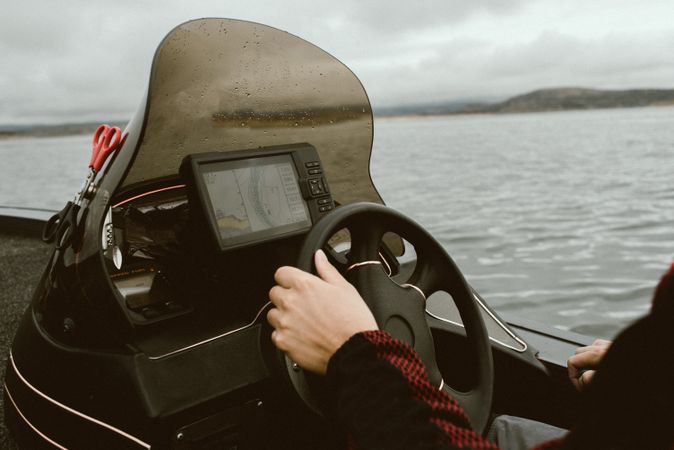 Tourist leading boat on high seas under control of navigator