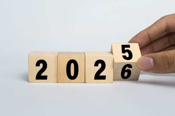 male hand flip wooden blocks with year 2025 to 2026