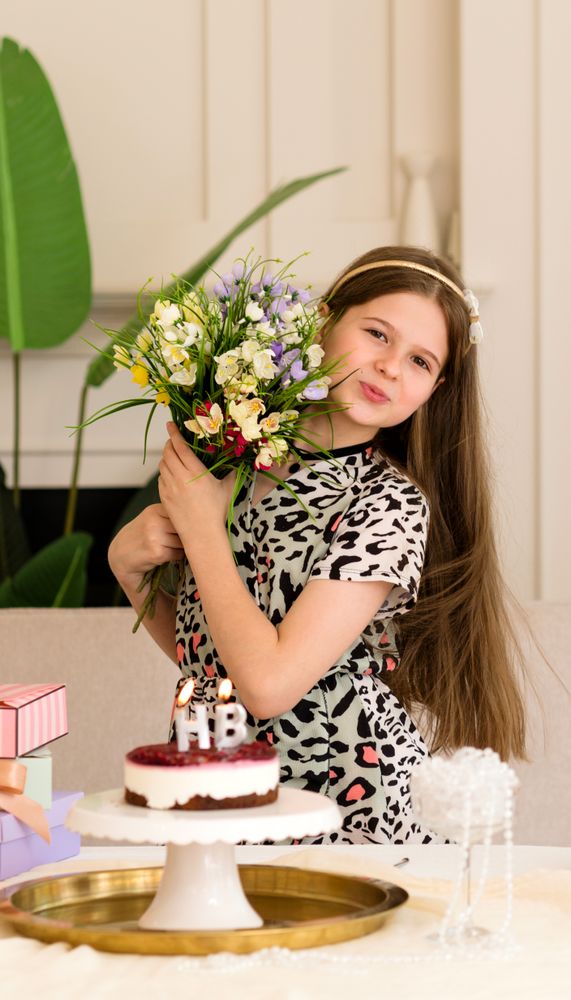Smiling girl holding bouquet of flowers