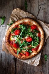 Appetizing pizza placed on wooden table