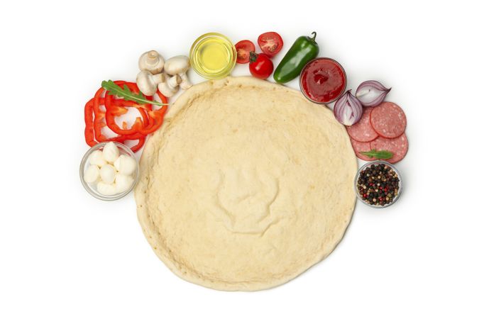 Dough and ingredients for cooking pizza isolated on blank background