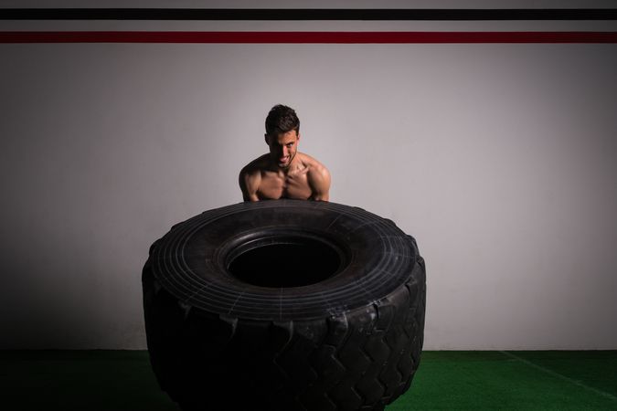 Man flipping big tires in gym