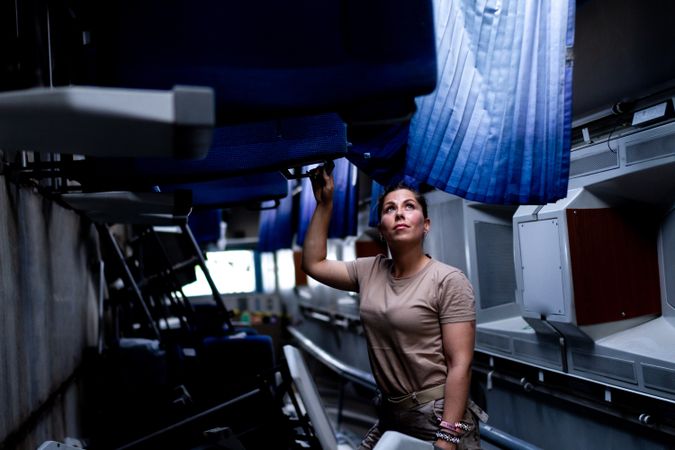 Military woman looking up inside vehicle