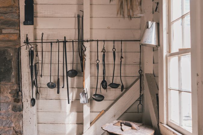 Hanging dark kitchen utensil on wooden wall