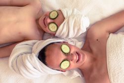 Mother with son with cucumber on eyes