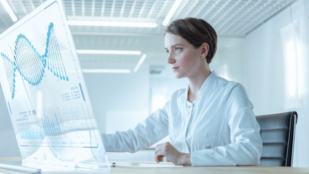 In the Near Future Female Doctor Works on Transparent Computer Display