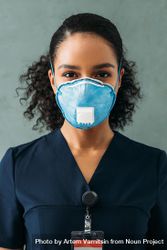 Black female medical professional in dark scrubs and protective face mask 4jZAR4