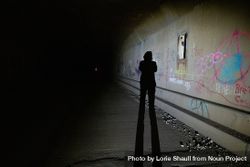 Shadow of person in grafitti tunnel 4jVVYr