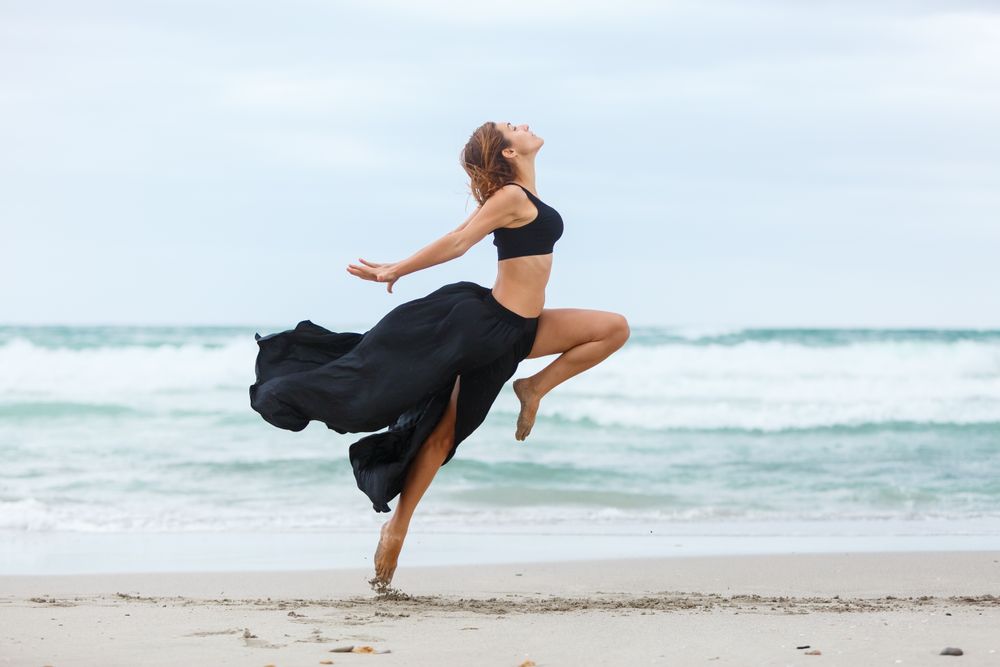 woman dancing near sea