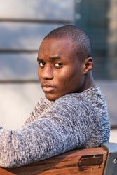 Black man resting on urban bench
