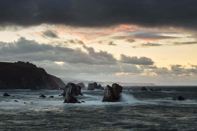 Storm with blustering waves on rocky coast