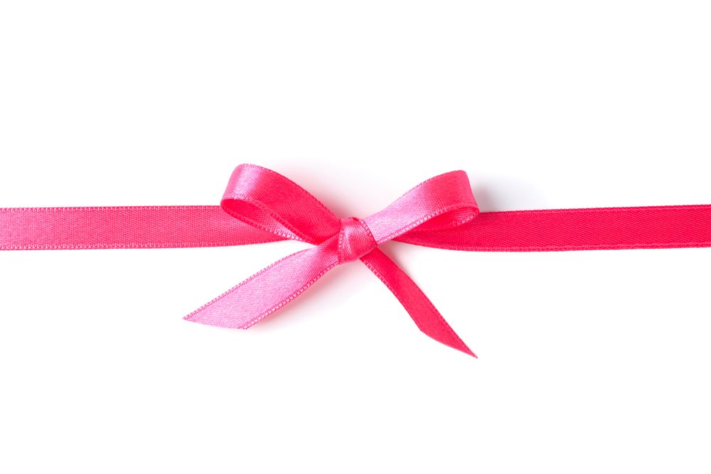 Pink ribbon with bow isolated on plain background. Gift concept