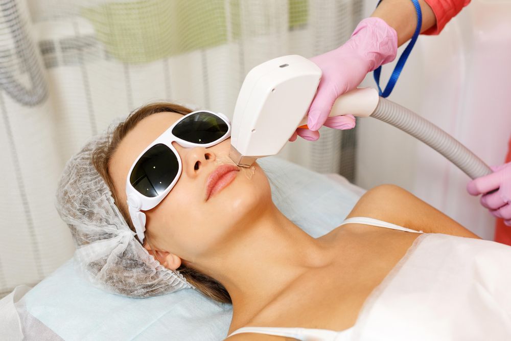 Female face with laser hair tool on cheek