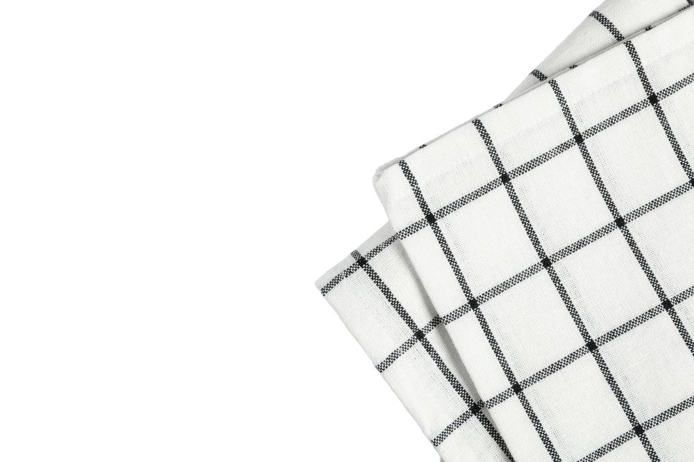 Folded fabric napkin isolated on plain background