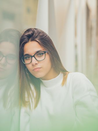 Young woman with standing against glass
