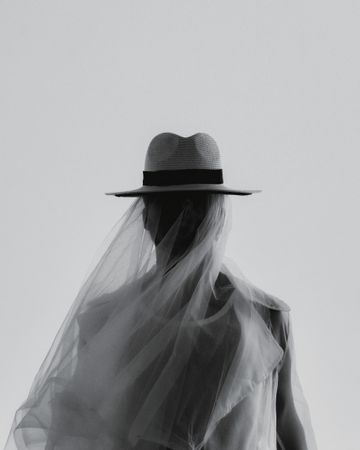Grayscale photo of man wearing a hat with veil