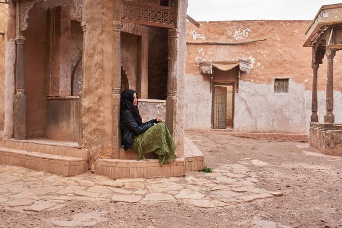 Woman on street between ancient buildings