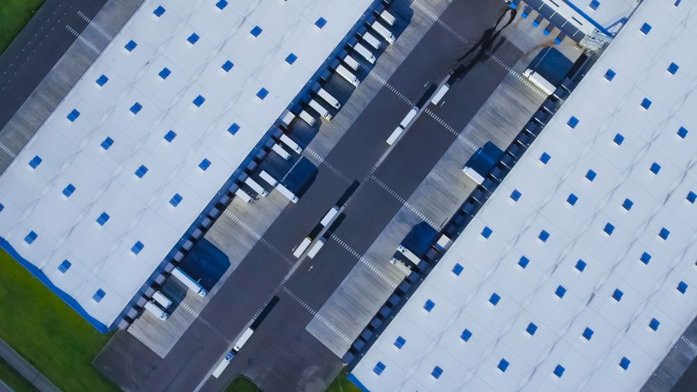 Aerial Shot of Loading Area where Many Trucks Are Loading