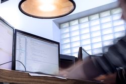 Person at desk with multiple screens