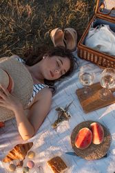 Woman resting in meadow on picnic