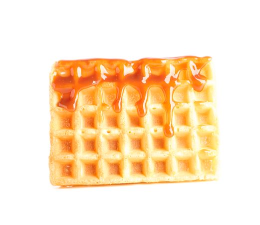 Waffle under caramel topping isolated on blank background